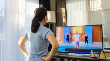women streaming a video workout from home