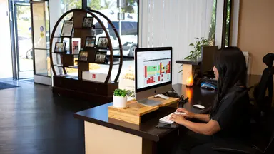 woman sitting at desk working on computer