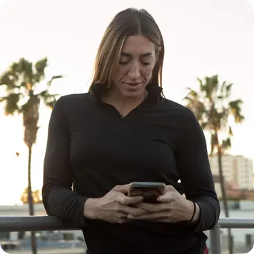A woman looking down at her phone