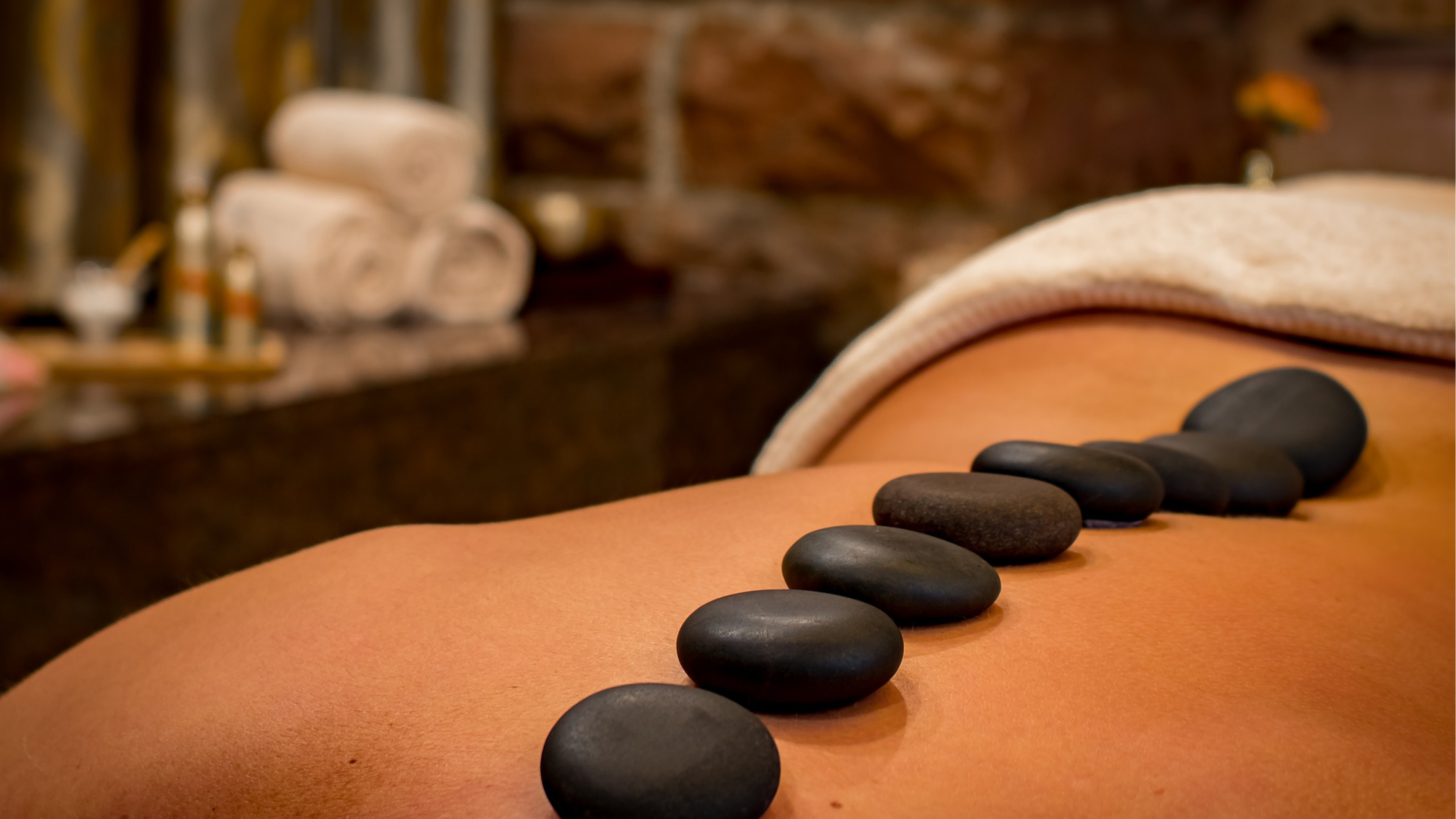 hot stones placed on persons back in spa