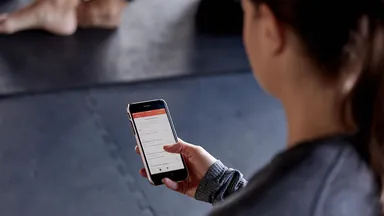 Woman using the MINDBODY app on her phone