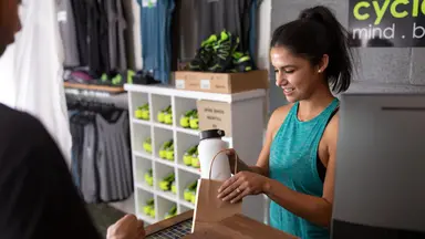 Employee selling retail at a fitness business