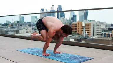 man doing yoga outside 