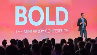 Presenter speaking on stage at BOLD