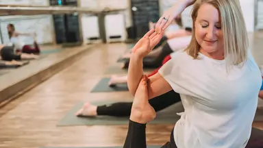 A woman practicing yoga at Studio South in Willamsburg, VA