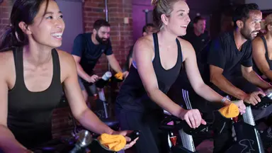 people working out in a cycling class