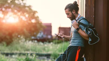 Man holding phone outside.