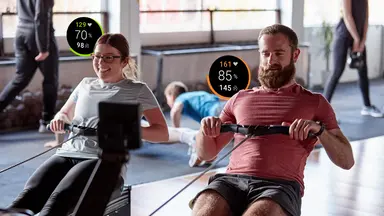 Two people rowing with their stats next to them