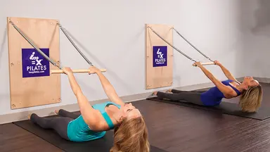 Two women using doing Pilates at IM=X