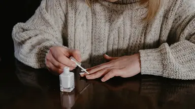 A woman painting her nails