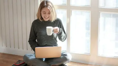 Woman on laptop with coffee