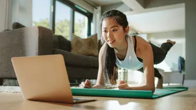 Woman doing an online workout from home