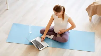 Pregnant woman working out from home virtually