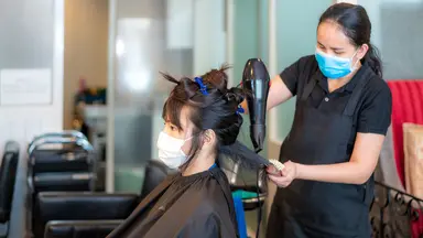 Person getting their hair done at a salon.