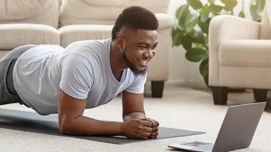 Man planking in front of a laptop at home