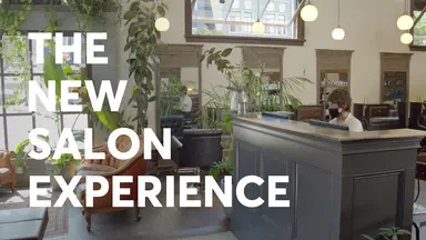 The New Salon Experience text over a salon front desk and entry area