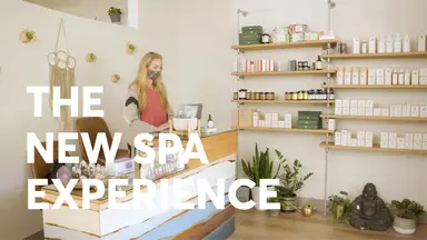 The New Spa Experience text over a spa owner at the front desk