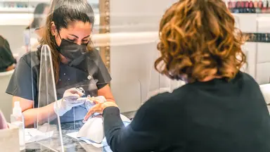 woman getting her nails done in a nail salon