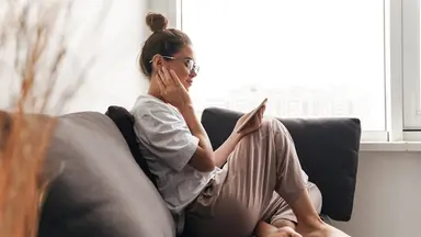 Woman on sofa looking at her phone