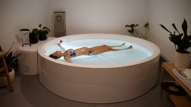 A woman in a float tank at Clear Mind