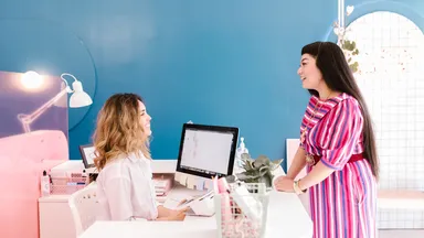two women at desk in salon spa