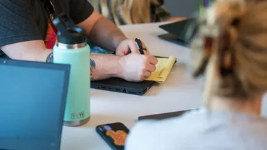 Taking notes with coworkers