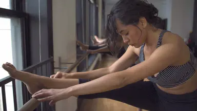 woman stretching in barre class