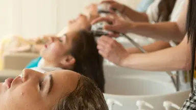 women getting hair washed at salon