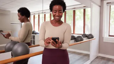 a woman using her phone in a studio