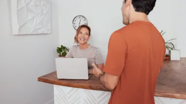 a man talking to a receptionist