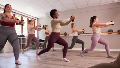 full barre class doing exercises with weights
