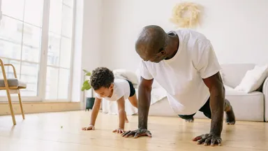A father exercising with his son.