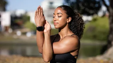 A woman performing breathwork exercises