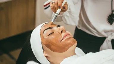 A woman getting a facial at the spa