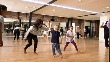 Students and an instructor in a dance class.