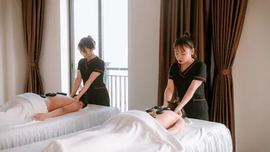 Two people receiving massages at a spa.