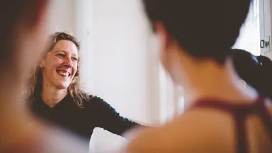 Person laughing while talking to client