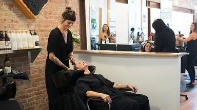 Woman washing hair in a salon