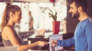 Person using gift card to pay at front desk