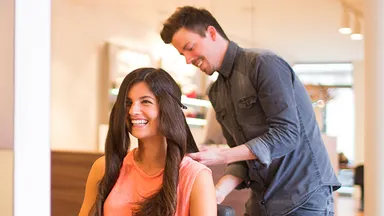 Client in chair talking with stylist