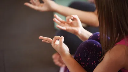 Child practicing yoga at Be Hot Yoga
