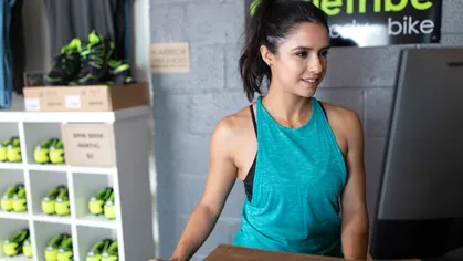 Woman using fitness software on her desktop computer