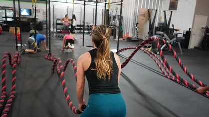 Woman using battle ropes