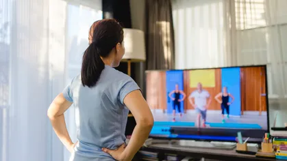 women streaming a video workout from home