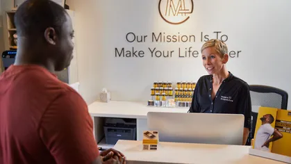 male customer at front desk of wellness business