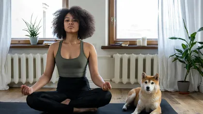 yoga studio owner on mat with her dog