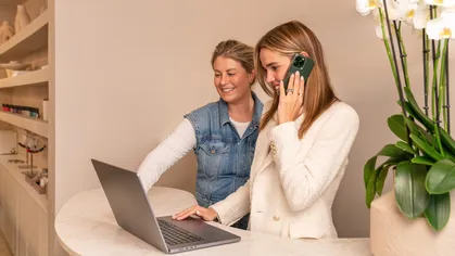 Two people on the laptop at the front desk