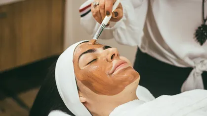 A woman getting a facial at the spa