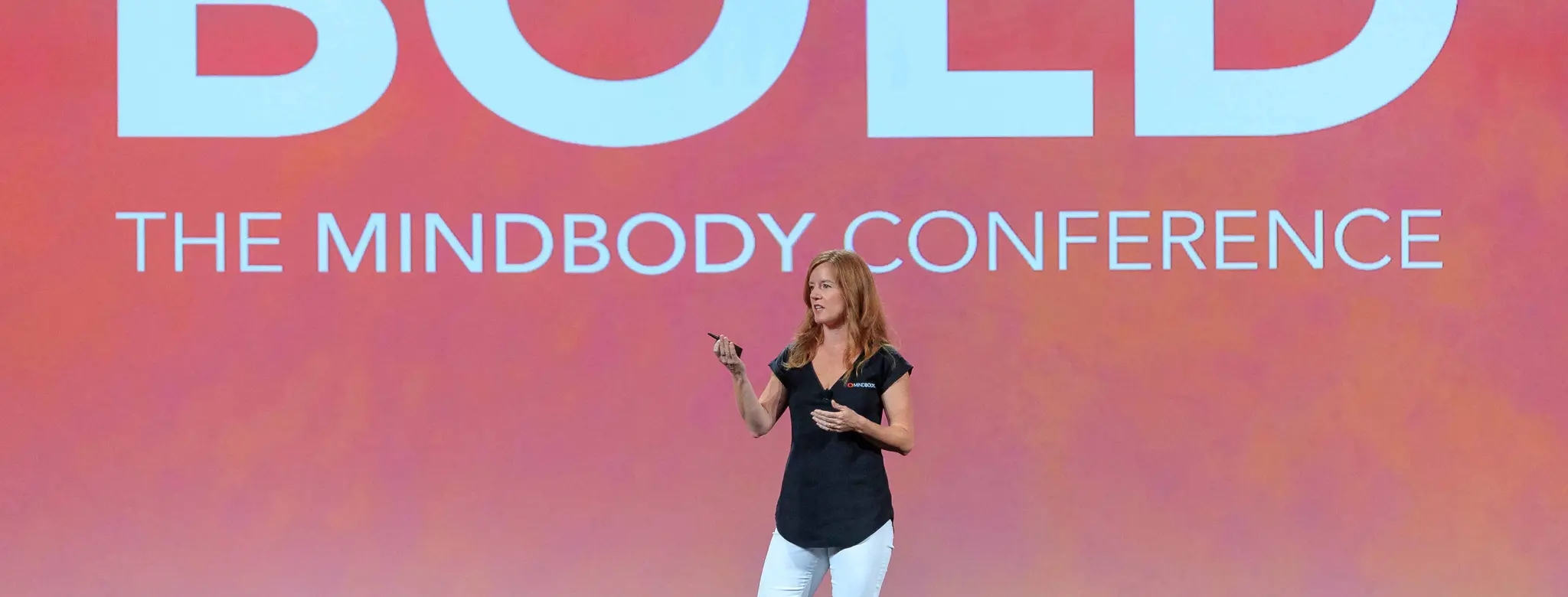 Presenter discussing wellness industry trends at BOLD