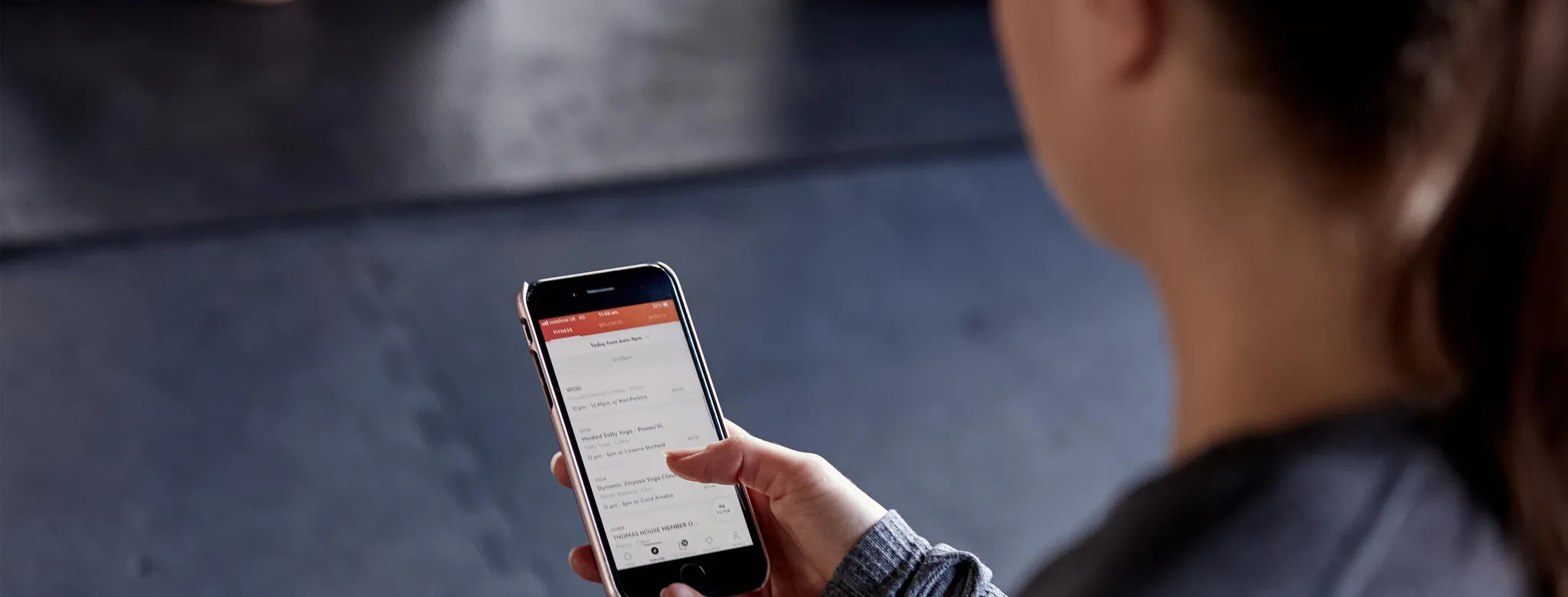 Woman using the MINDBODY app on her phone